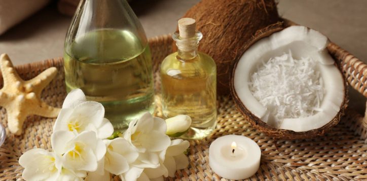 tray-with-spa-oil-coconuts-candle-flowers-table-2